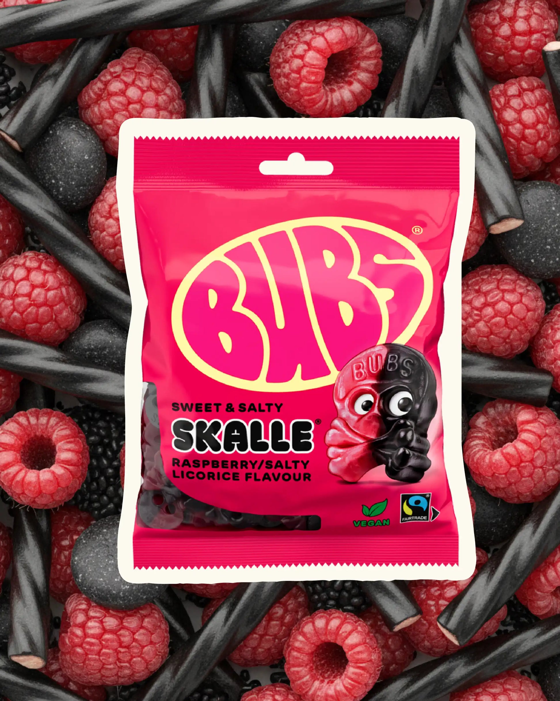 BUBS Swedish vegan candy - Raspberry Liquorice Skulls on a background of rasberry and licorice